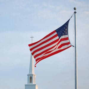 freedom from sin American flag flying in front of a church