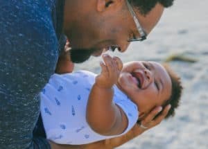 Photo of a dad holding a young baby.