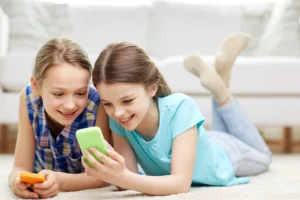 two young girls on their cell phones