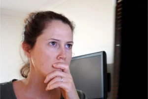 Serious woman looking at her laptop