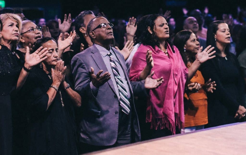 Photo of a group of Christians praying in church.