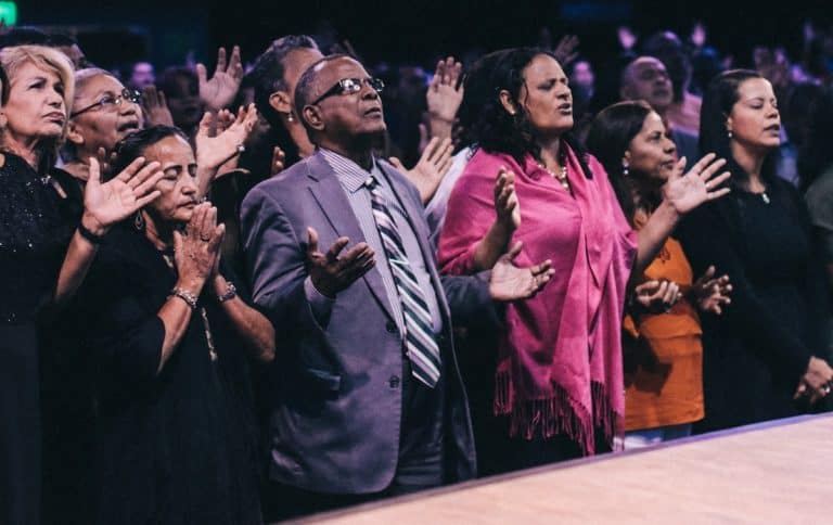 Photo of a group of Christians praying in church.