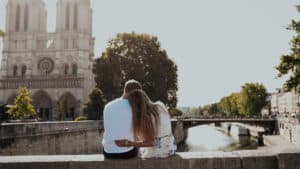 Couple-embracing-in-front-of-Notre-Dame-in-Paris