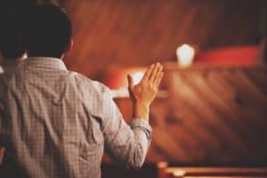 Man singing in worship at a church