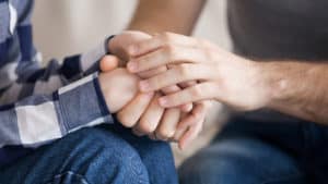 Hands-of-married-couple-together-in-prayer