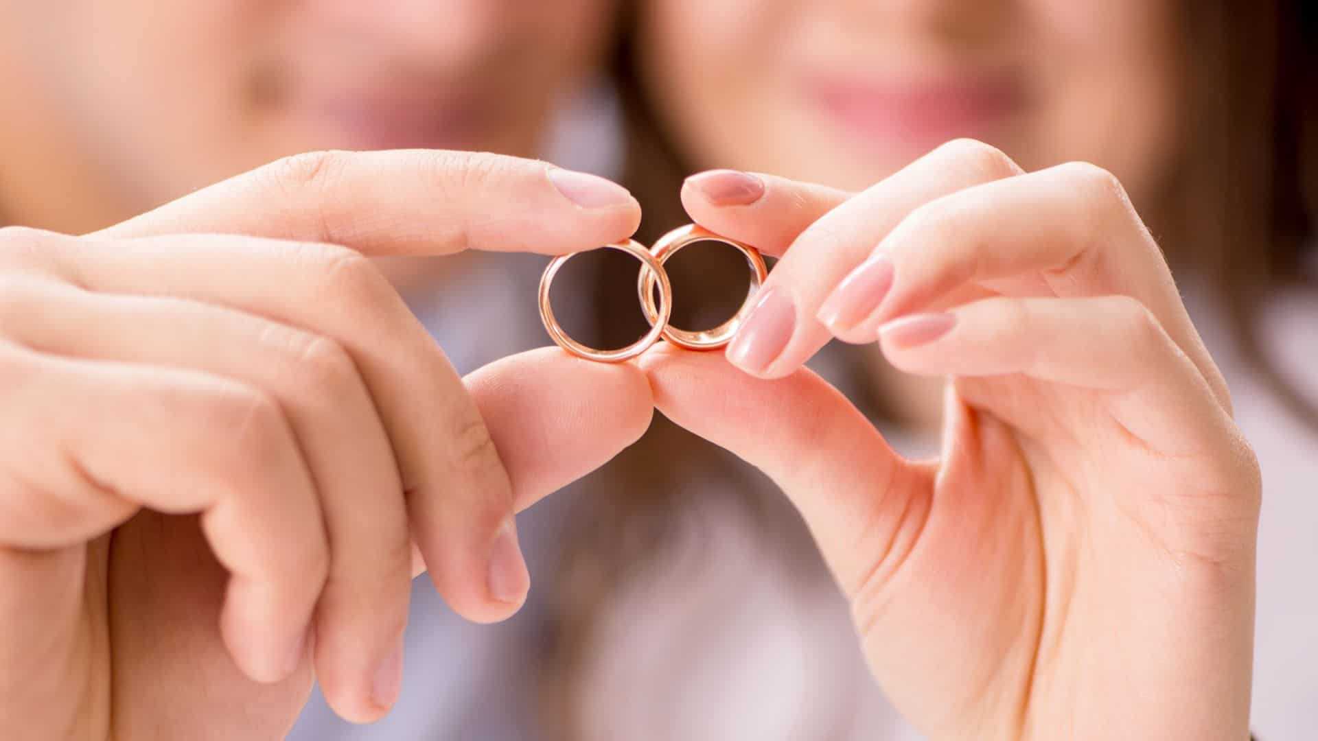 Prayers for marriage restoration. A man and woman's prayers for marriage restoration have paid off. They smile and hold their wedding bands together as if they are interlocked.