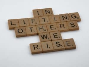 Scrabble words that say In Lifting Others We Rise
