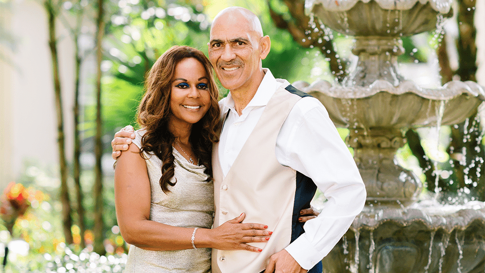 Uncommon Evangelism - Tony and Lauren Dungy pose for a photo in front of a fountain