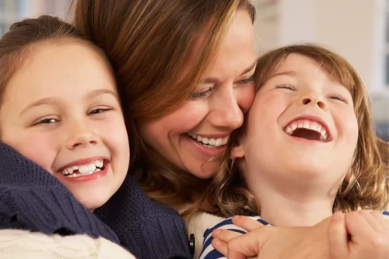 Mother hugging her son and daughter