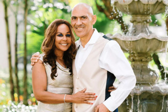 Uncommon Evangelism - Tony and Lauren Dungy pose for a photo in front of a fountain