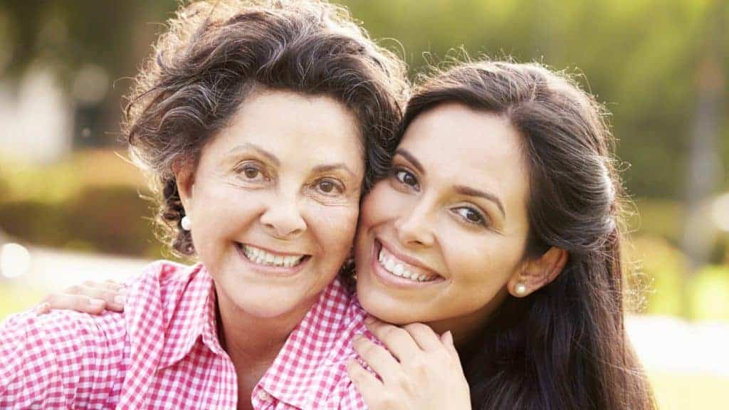 Parenting adult children through prayer. Mother and daughter smiling, posing together
