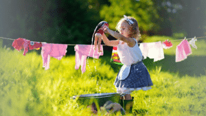 Raising Responsible kids like this little girl pretending to hang up laundry on the clothes line