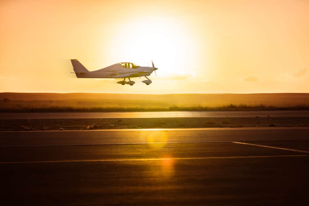 Small plane on the runway background of sunrise