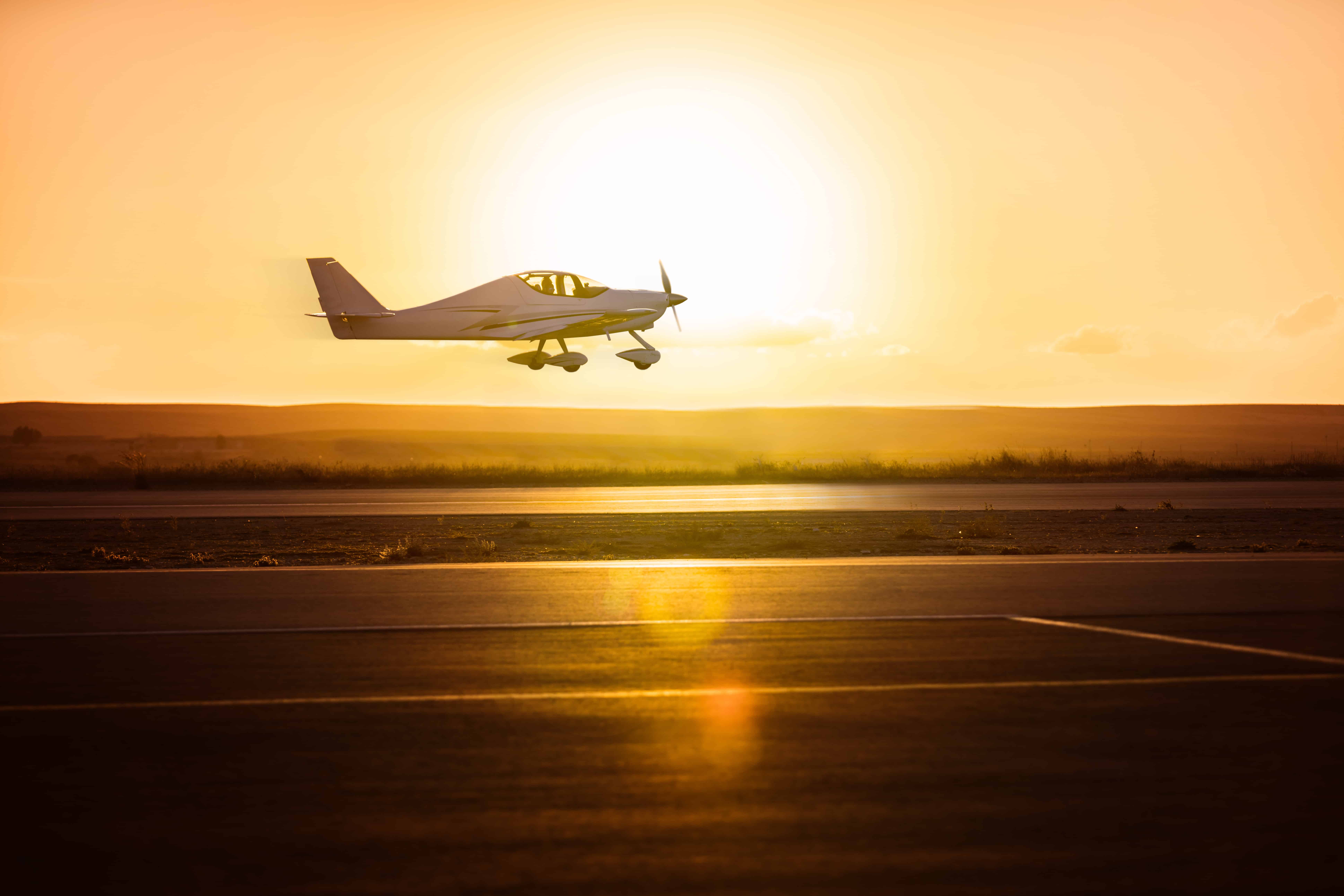 Small plane on the runway background of sunrise