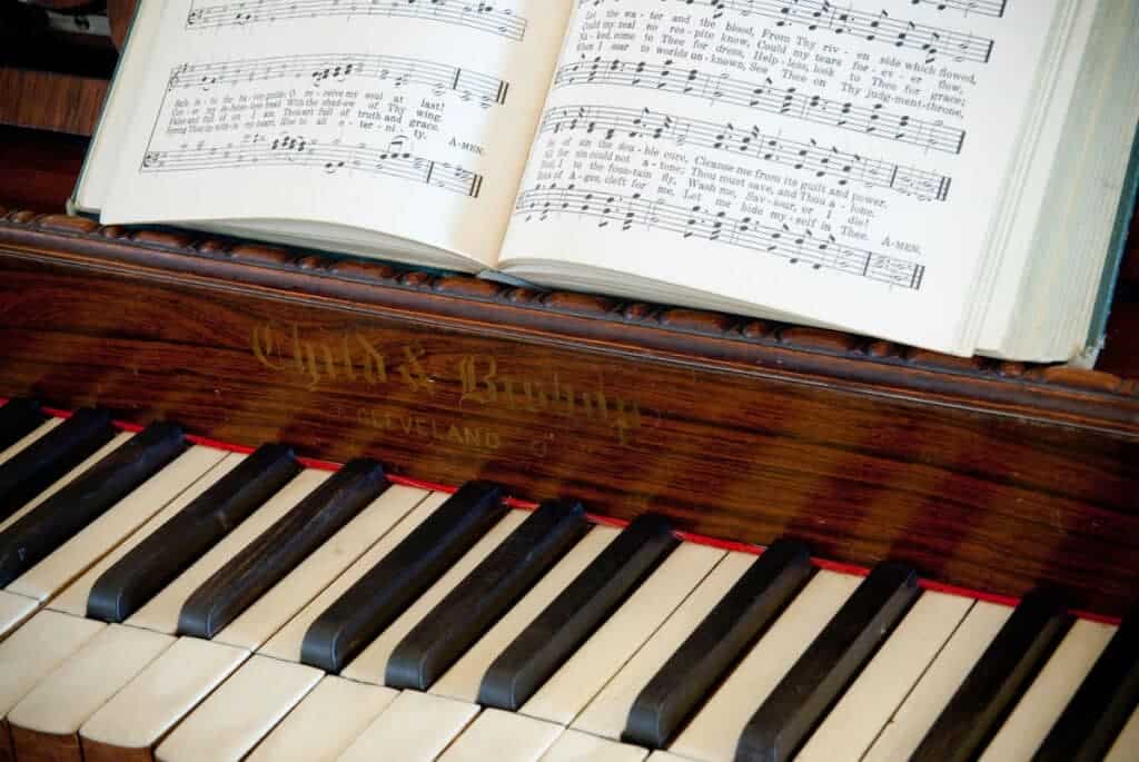 Photo of piano keyboard and music book.