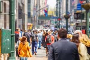 USA, New York, Manhattan streets. Skyscrapers and crowded streets, cars and busy people walking downtown in a spring sunny day.