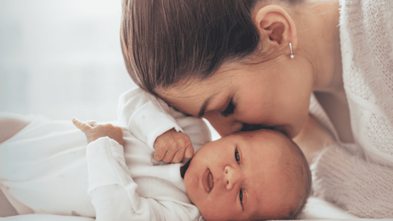 Bible verses offer solace for parents facing depression. Young woman kissing her newborn baby girl.