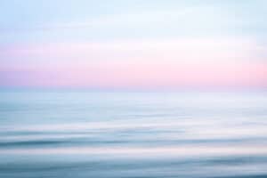 Abstract sunset sky and ocean nature background with blurred panning motion.