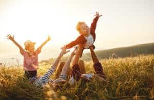 Happy family: mother, father, children son and daughter on nature on sunset