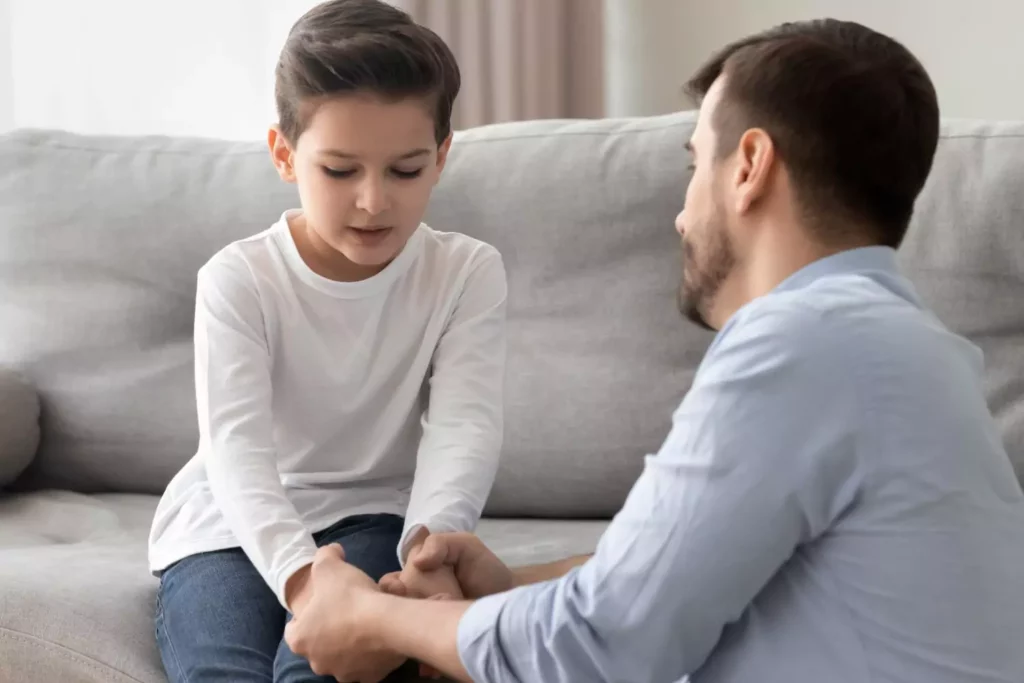 Kids mess-up. This father is talking to his son on the couch letting him know it's okay.