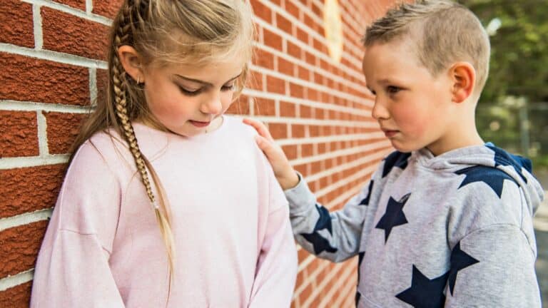 Teaching empathy to your children by teaching them to serve others. This is a little boy comforting his sister.