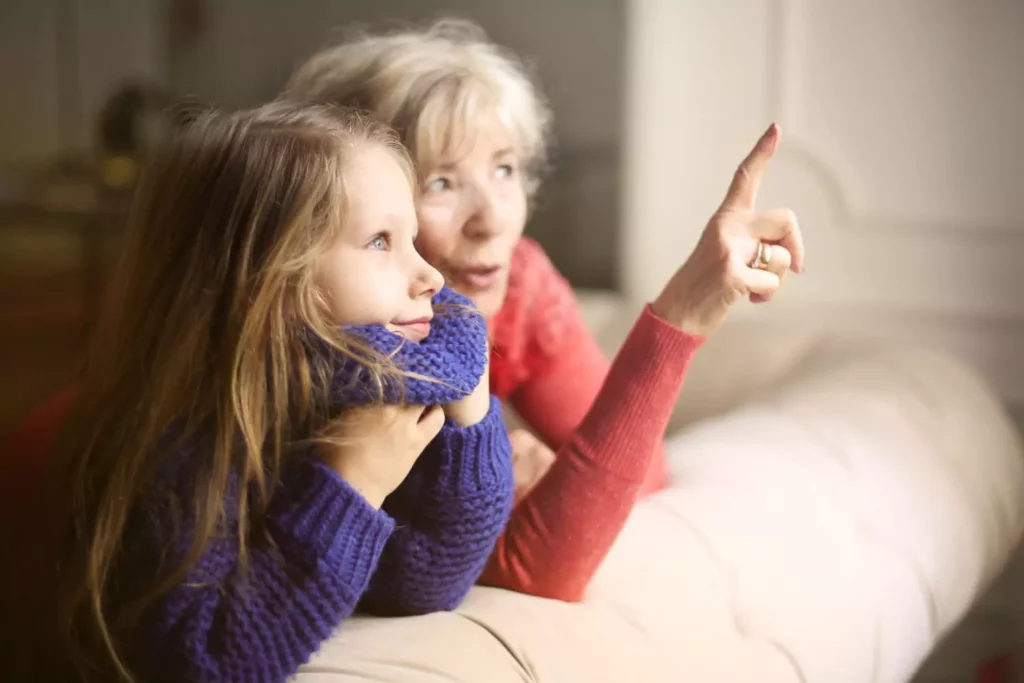 grandmother sharing bible verses and talking about God with her granddaughter