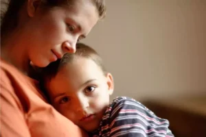 Young widow holding her son