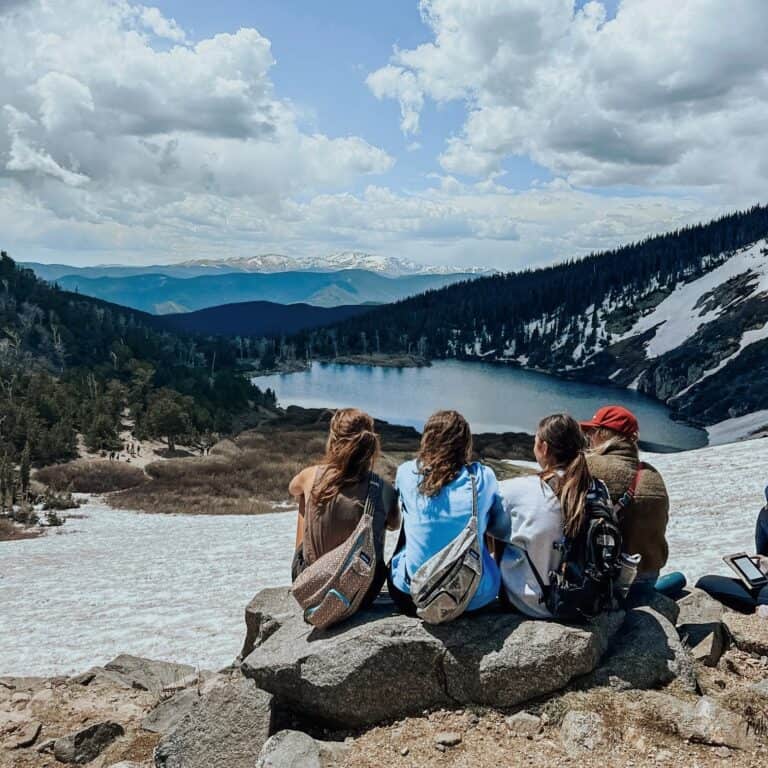 girls sitting on top of mountain