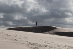 Christian depression man standing alone in a desert