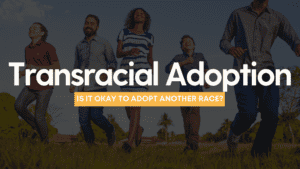 A biracial family runs towards the camera. The words "Transracial Adoption" are on top.
