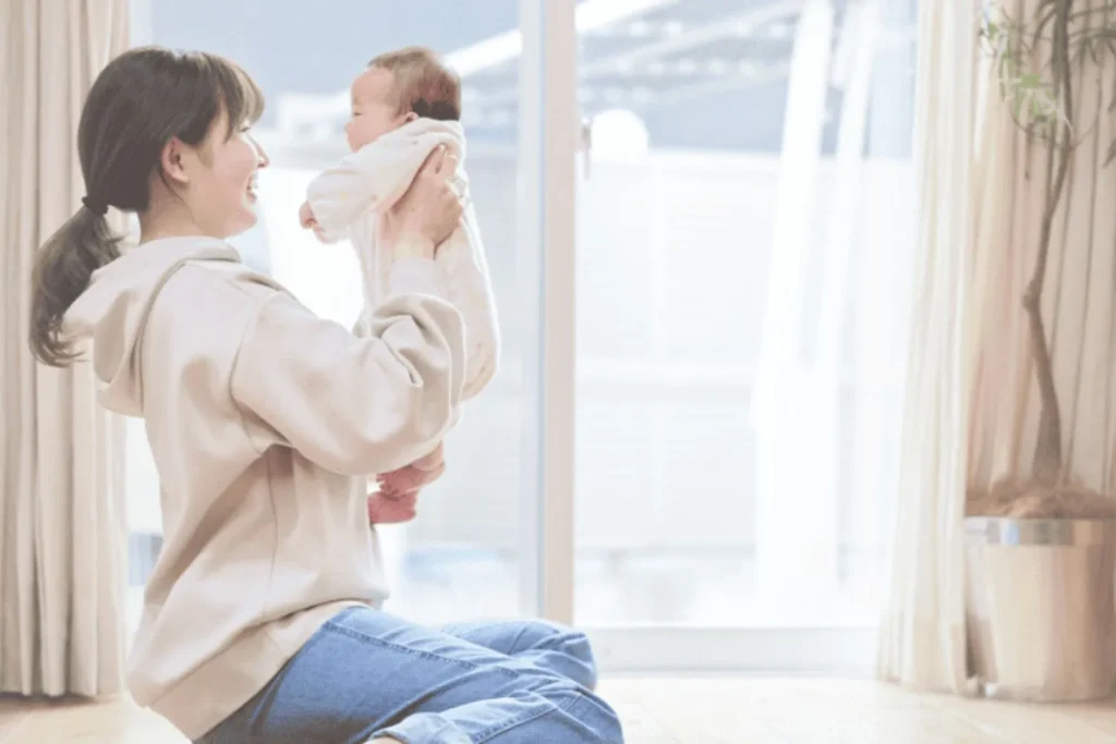 Young mother smiling and holding her infant