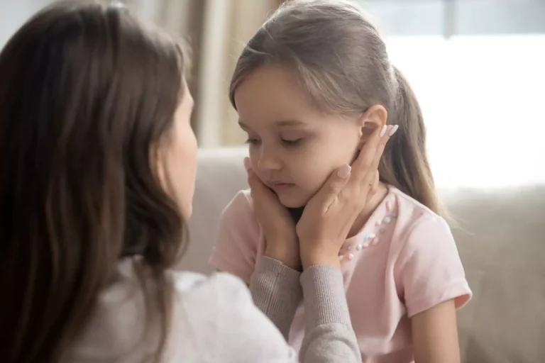 Mother with her daughter's face in her hands giving her godly discipline in love