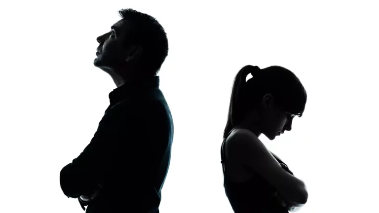 Silhouette of a man and woman standing with their arms crossed, facing away from each other. They have been fighting in marriage and wonder what the Bible says about conflict.