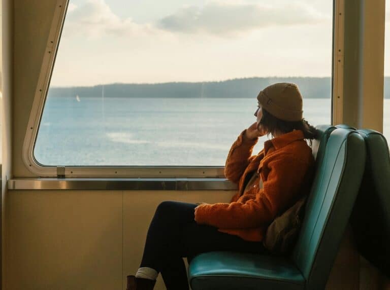 person on boat or train looking out over ocean