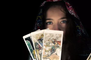 teen girl holding up taro cards