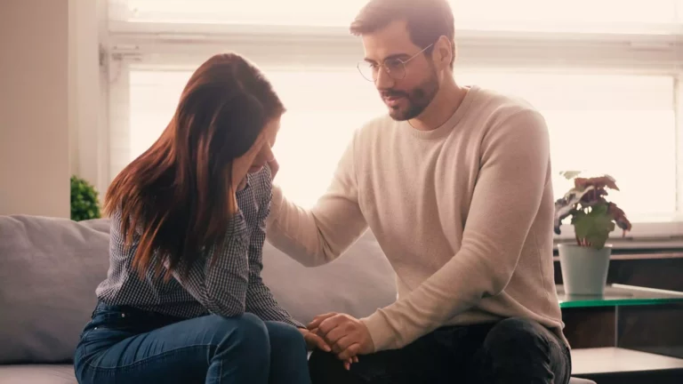 Photo of a man actively listening to his spouse to strengthen their relationship.