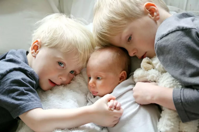 newborn baby surrounded by toddlers. best gifts for ages 0-3
