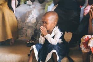 A little girl praying to God in Church shows us the purpose and power of prayer.