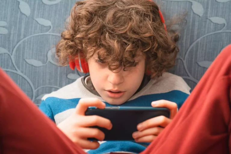 Boy engrossed in the screen on his phone