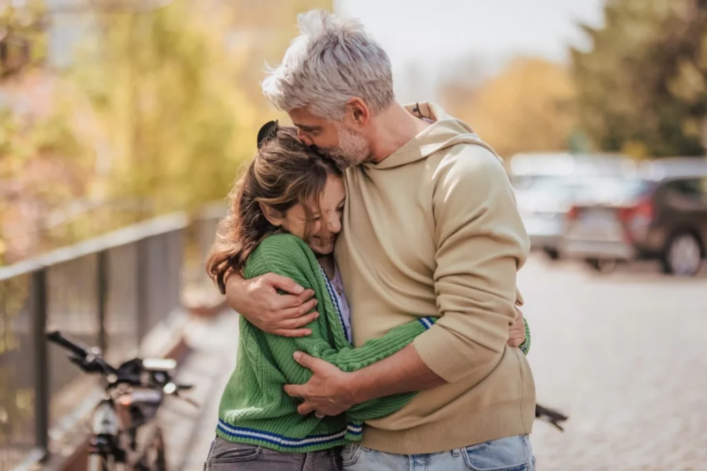 Dad hugging his daughter