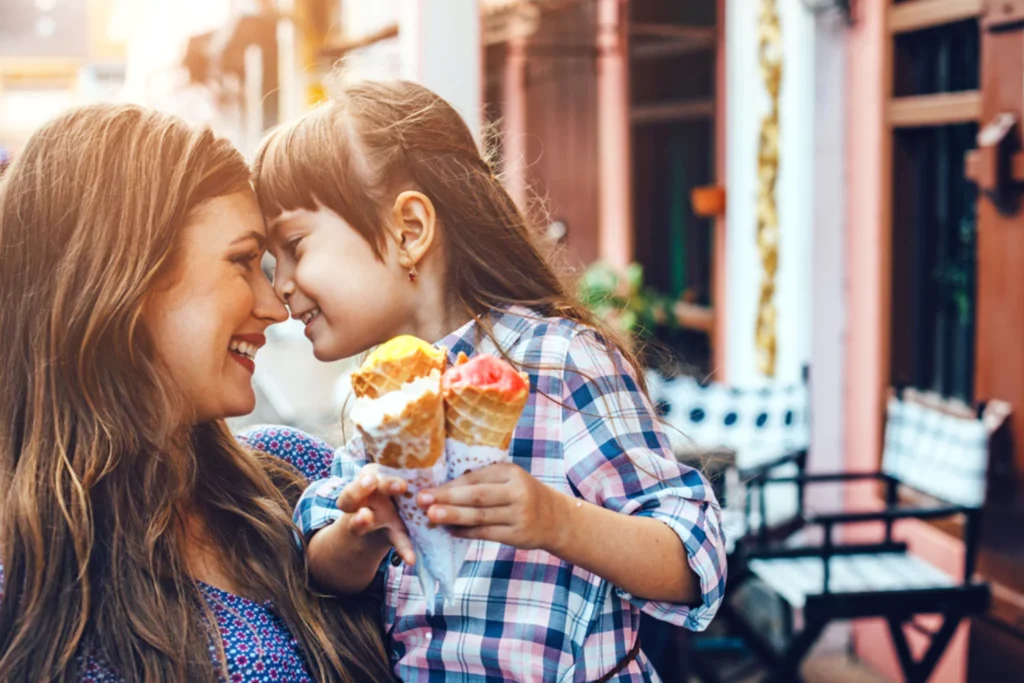 6 year old girl and her mom eating ice cream