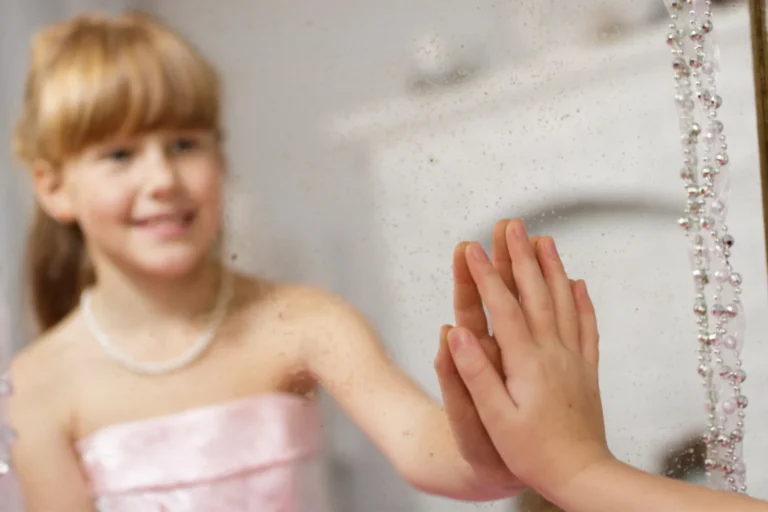 young girl with her hand on the mirror- identity in Christ