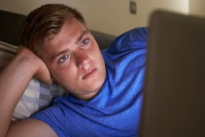 teen in bed with a laptop his parents suspect porn use.