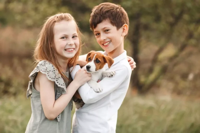 Teaching children about love. This bother and sister are holding a lovable beagle pupp.