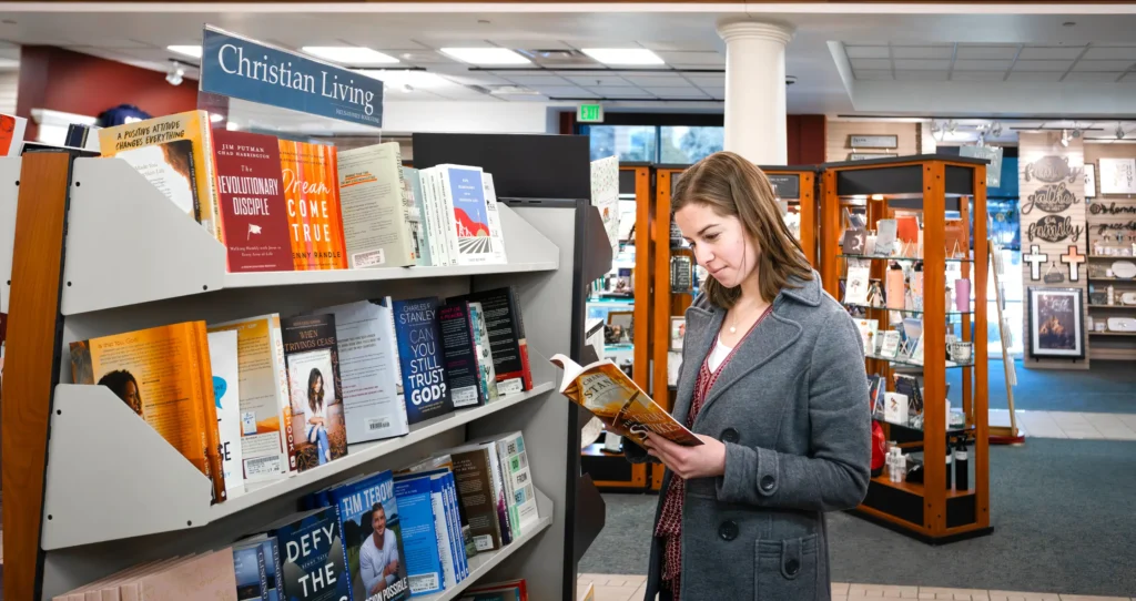 A young woman looks at a book in the Focus on the Family Bookstore