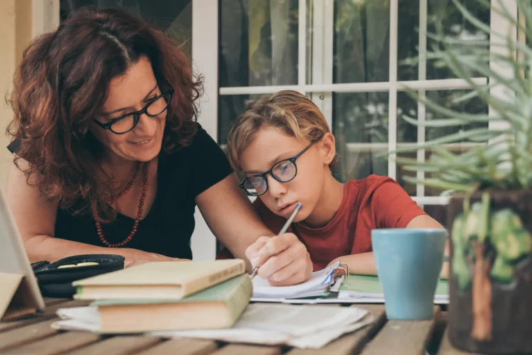Mother and son at the table, going over school lesson
