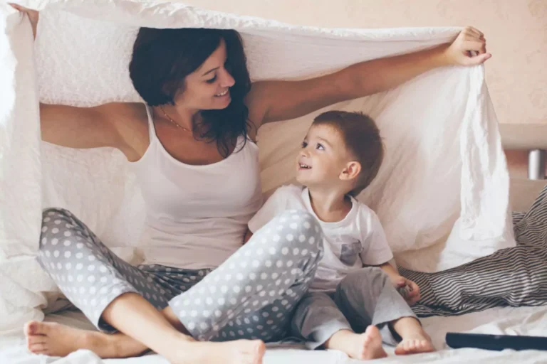 Mom sitting and smiling with her young child