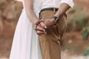 Newlywed couple holding hands on their honeymoon