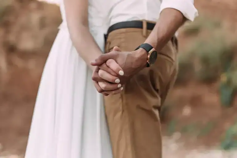 Newlywed couple holding hands on their honeymoon
