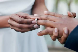A bride slips a ring on the finger of her groom. Traidtional marriages vows are still important. Here's why.